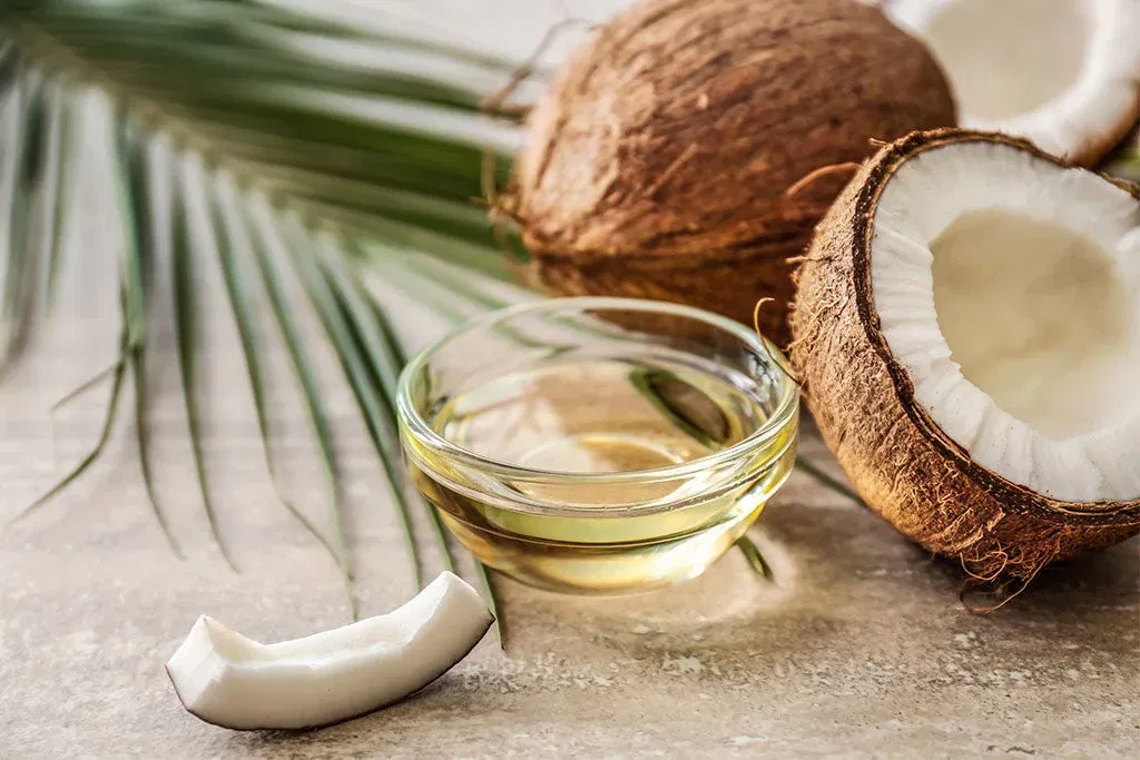For making this coconut oil infusion, take one cup of coconut oil, heat it until it gets a little bit warm, then add some curry leaves to that oil, let it cool down, and then transfer that oil into a jar and use it for your hair.