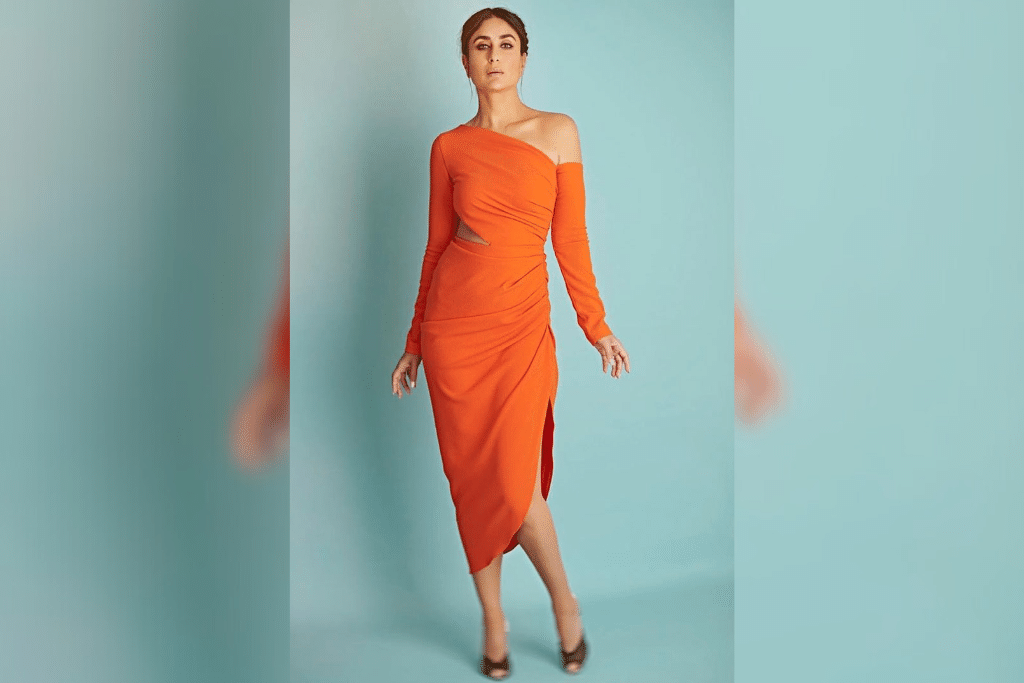 Polished And Perfect: Kareena donned a vibrant orange ankle-length dress that boasted an elegant cut-out around the waist. She chose to keep her accessories and makeup understated and styled her hair in a braided ponytail to complete her look. (Photo Courtesy: Pinterest)