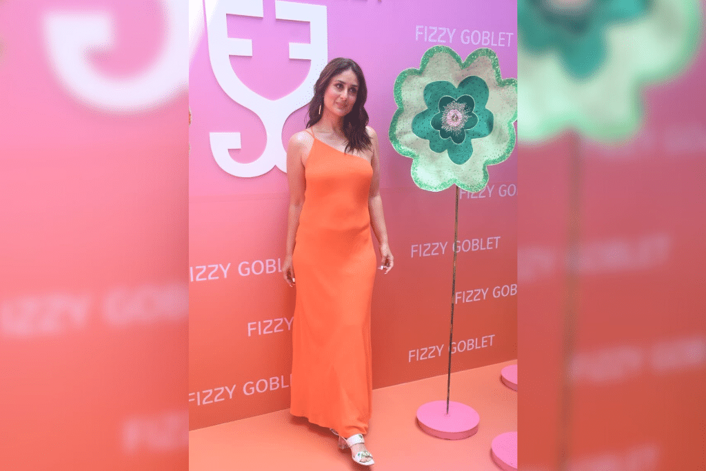 Orange Is The New Black: Kareena donned a slinky one-shoulder tangerine-hued ankle-length dress. The star rounded off her ensemble with gold dangler earrings, white block heels and tousled hair. (Photo Courtesy: Pinterest)