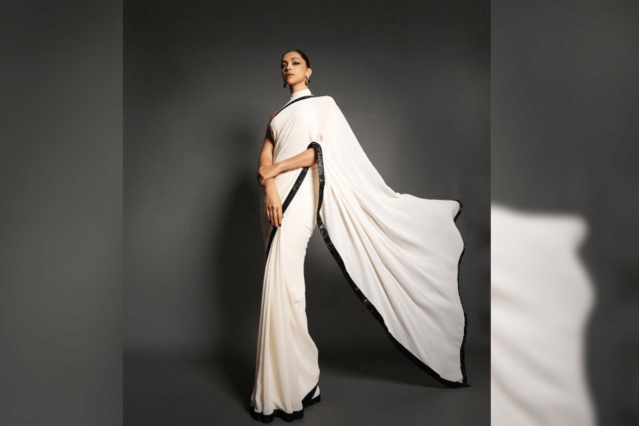 Deepika Padukone: During the Jawan promotion event, Deepika donned a simple yet elegant white saree designed by Sabyasachi, adorned with a striking black sequined border. She complemented her attire, with a chic halter neck blouse. She rounded off her look with emerald stud earrings, a bold winged eyeliner and a subtle nude lip. (Photo Courtesy:@deepikapadukone)